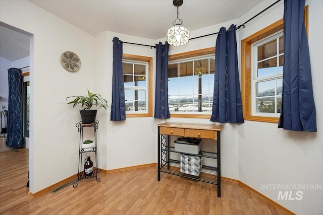 interior space with baseboards and wood finished floors