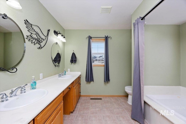 bathroom featuring toilet, a sink, and visible vents