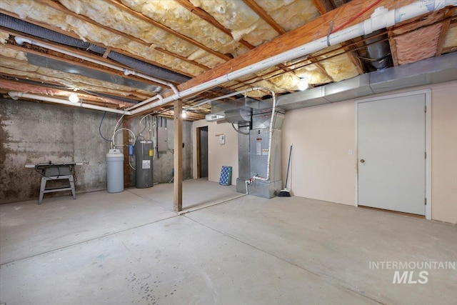 unfinished basement featuring heating unit, electric panel, and electric water heater