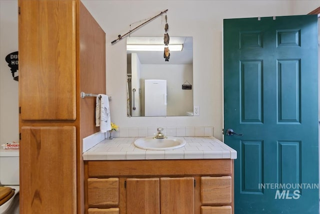 bathroom featuring vanity and toilet