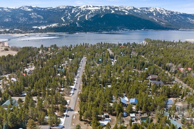 birds eye view of property with a water and mountain view
