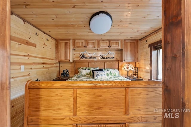bedroom featuring wooden walls and wooden ceiling