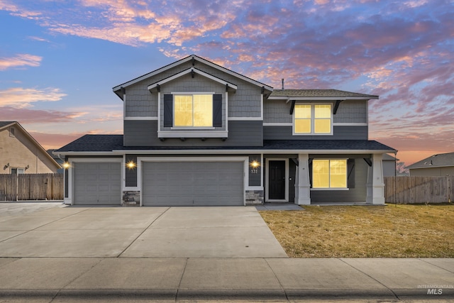 craftsman-style house featuring concrete driveway, an attached garage, roof with shingles, and stone siding