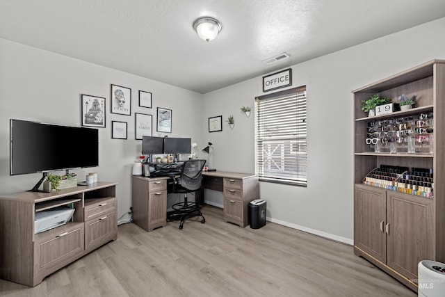 office space featuring light wood finished floors and baseboards