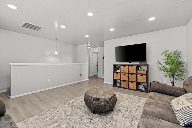 living area featuring wood finished floors, recessed lighting, and baseboards