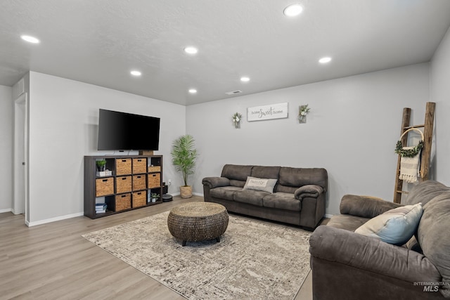 living area featuring wood finished floors, recessed lighting, and baseboards