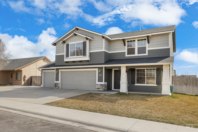 craftsman inspired home featuring an attached garage, a porch, driveway, and roof with shingles