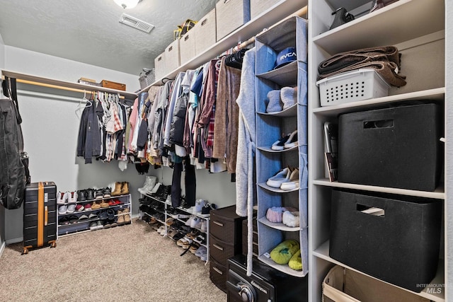 walk in closet featuring carpet floors