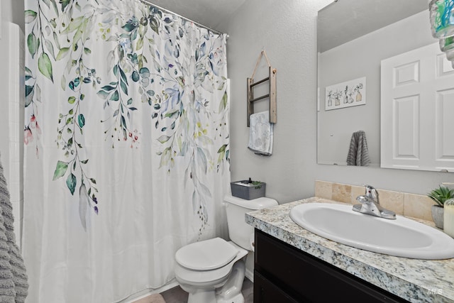 full bathroom featuring toilet, vanity, and curtained shower