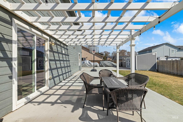 view of patio / terrace featuring a storage unit, a pergola, an outdoor structure, and outdoor dining area