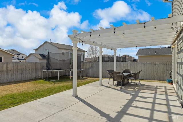 view of patio / terrace with a trampoline, a pergola, and a residential view