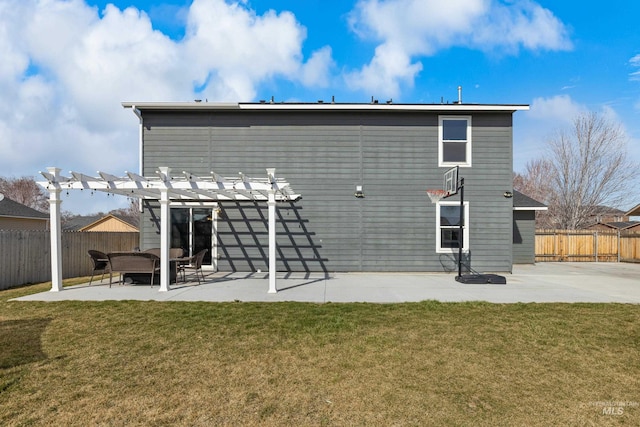 rear view of property with a pergola and a patio area
