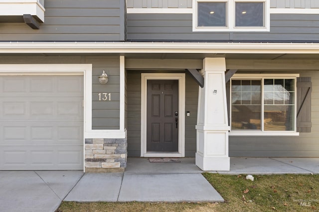 property entrance with a porch and stone siding