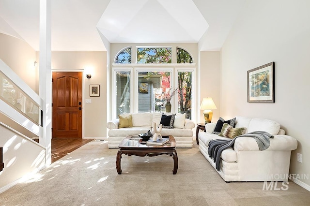 living room with light hardwood / wood-style floors and lofted ceiling