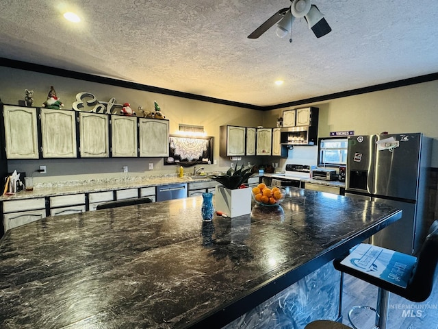 kitchen featuring a textured ceiling, ceiling fan, appliances with stainless steel finishes, and crown molding