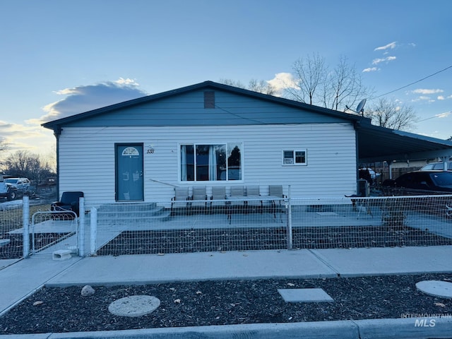 bungalow with a fenced front yard and a gate