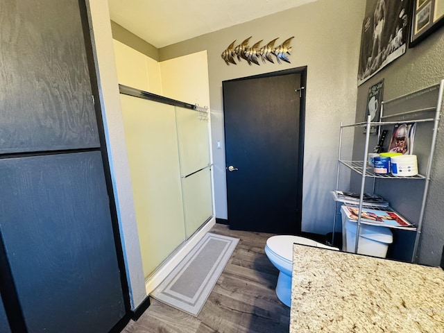 full bathroom featuring visible vents, a shower stall, toilet, and wood finished floors