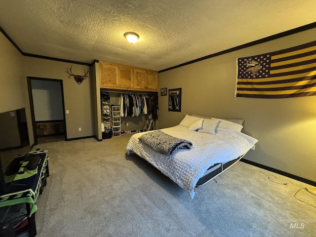 bedroom featuring a closet, light colored carpet, crown molding, and a textured ceiling