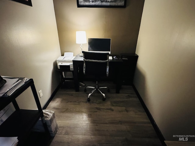 office space with baseboards and wood finished floors