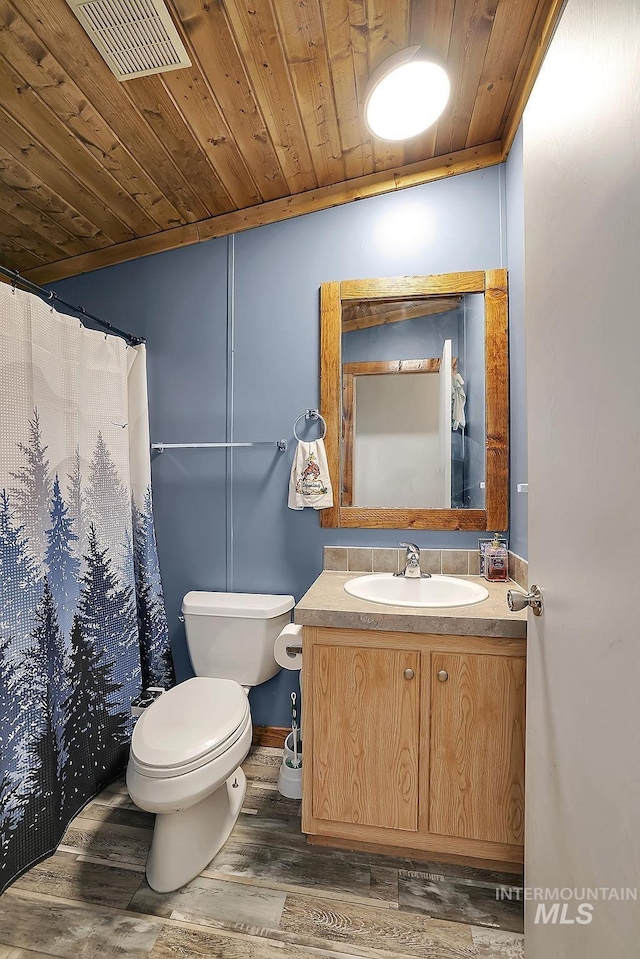 bathroom featuring hardwood / wood-style floors, vanity, toilet, and wood ceiling