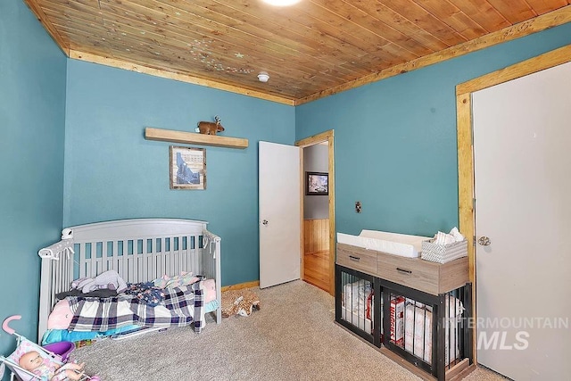 carpeted bedroom featuring wood ceiling