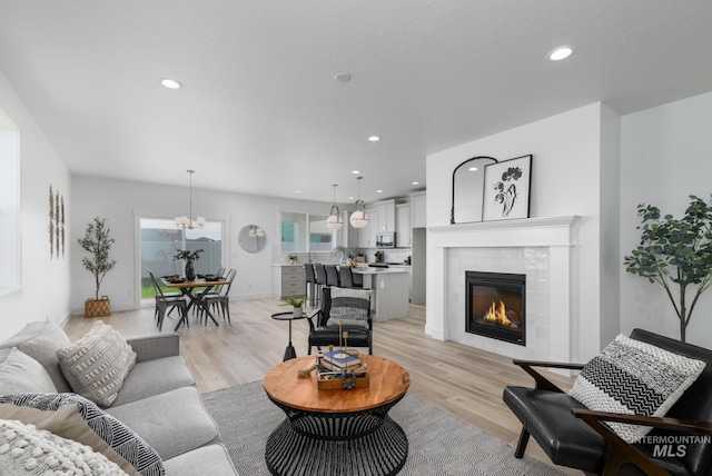 4541 E Fortuna Dr, Nampa, ID 83687 - living room featuring recessed lighting, light wood finished floors, and a tile fireplace