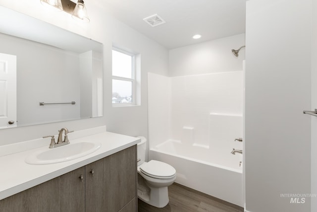 2887 N Rocky Bottom Way, Kuna, ID 83634 - bathroom featuring toilet, vanity, wood finished floors, and shower / bath combination