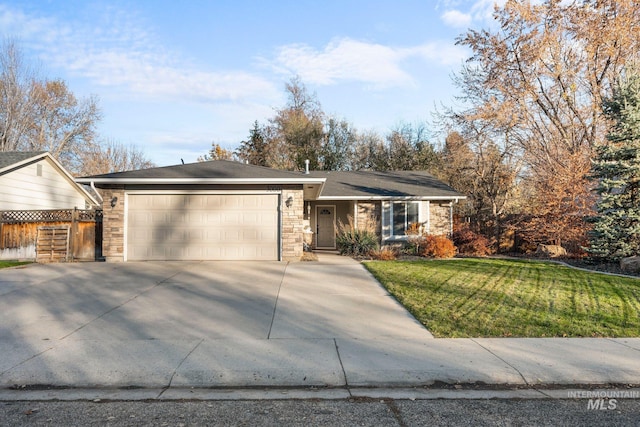 ranch-style house featuring a front yard and a garage