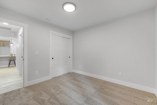 unfurnished bedroom featuring carpet and a closet