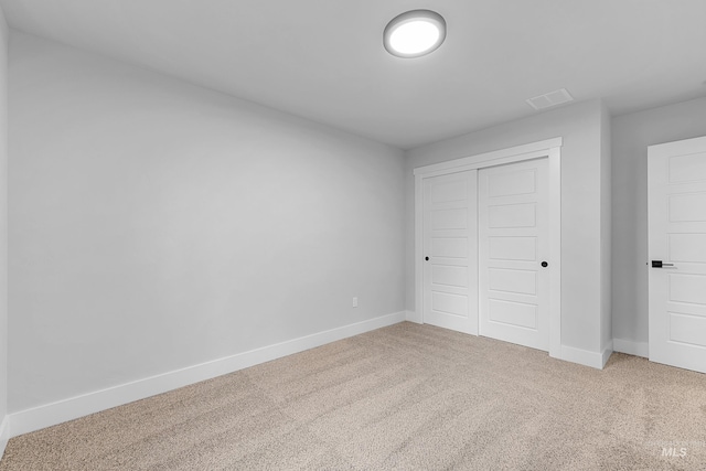 unfurnished bedroom featuring a closet and carpet