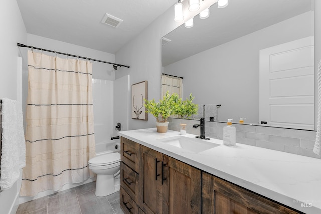 full bathroom with tasteful backsplash, vanity, tile patterned flooring, toilet, and shower / bath combo with shower curtain