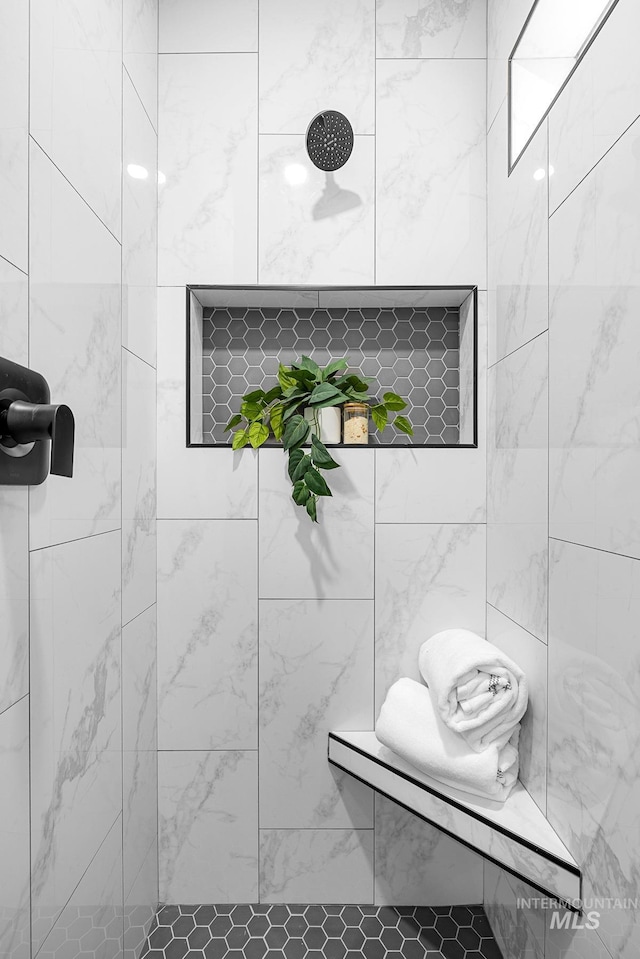 bathroom with tiled shower