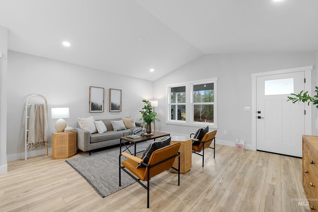 living room with light wood-type flooring and lofted ceiling