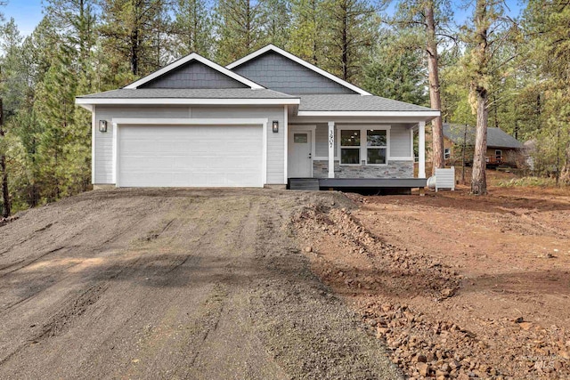 view of front of home with a garage and a porch