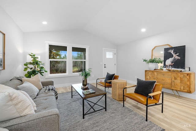 living room with lofted ceiling and light hardwood / wood-style flooring