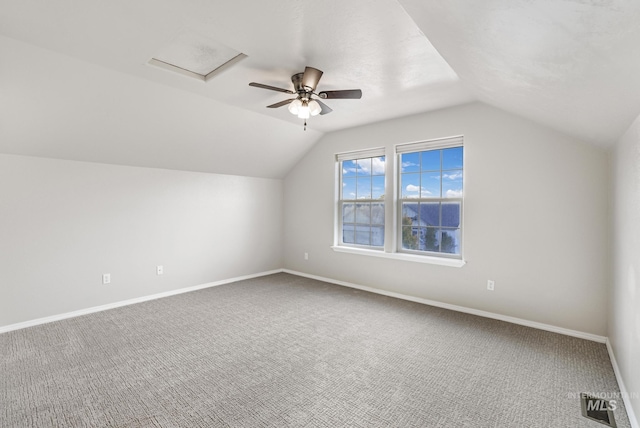 additional living space featuring baseboards, carpet flooring, lofted ceiling, and a ceiling fan