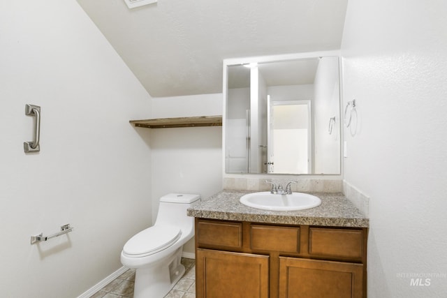 bathroom with toilet, tile patterned flooring, and vanity