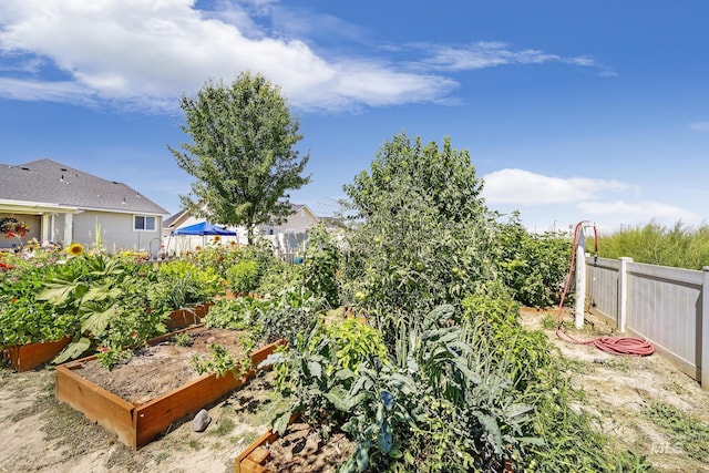 view of yard with fence and a vegetable garden