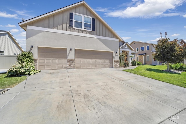 craftsman house featuring driveway, an attached garage, board and batten siding, and a front yard