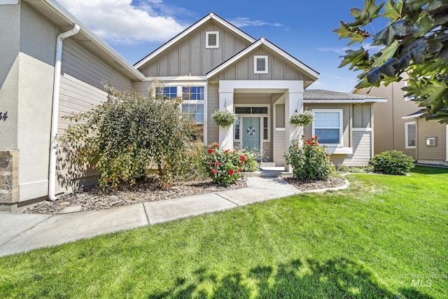 view of front of home featuring board and batten siding and a front lawn