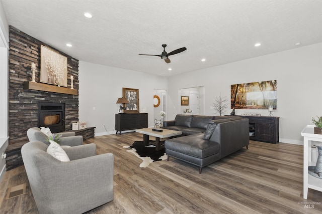 518 Bass Run Ln, Marsing, ID 83639 - living room featuring a stone fireplace, ceiling fan, wood finished floors, and recessed lighting