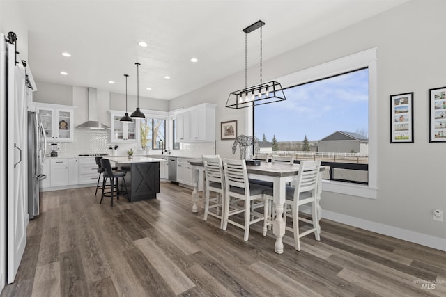 518 Bass Run Ln, Marsing, ID 83639 - dining room with a barn door, dark wood-style flooring, and recessed lighting