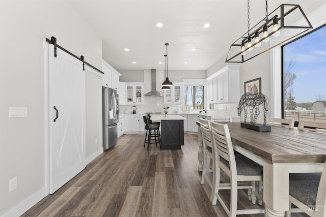 518 Bass Run Ln, Marsing, ID 83639 - dining space with a barn door, dark wood-type flooring, and recessed lighting