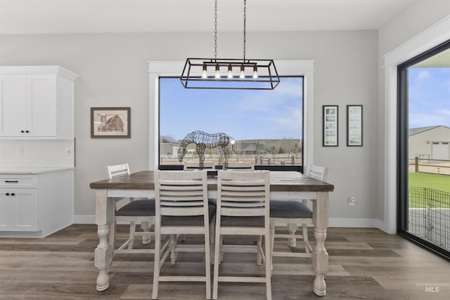 518 Bass Run Ln, Marsing, ID 83639 - dining space featuring wood finished floors and a chandelier