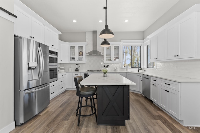 518 Bass Run Ln, Marsing, ID 83639 - kitchen with appliances with stainless steel finishes, wall chimney exhaust hood, backsplash, white cabinetry, and glass insert cabinets