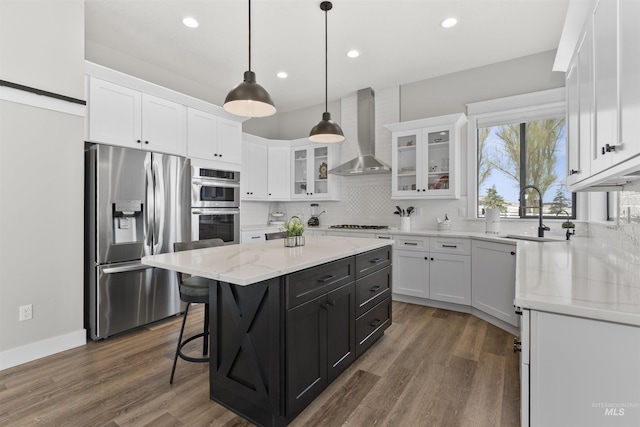 518 Bass Run Ln, Marsing, ID 83639 - kitchen featuring stainless steel appliances, wall chimney range hood, white cabinets, and recessed lighting
