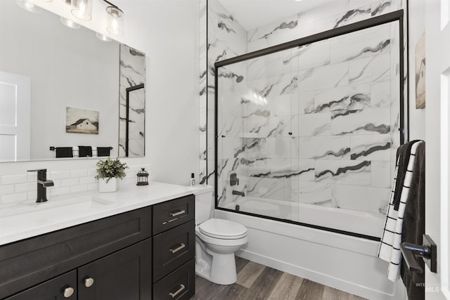 518 Bass Run Ln, Marsing, ID 83639 - full bathroom featuring vanity, enclosed tub / shower combo, decorative backsplash, and wood finished floors