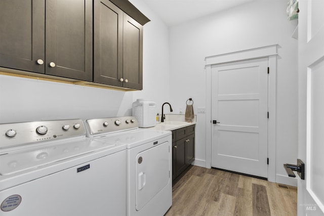 518 Bass Run Ln, Marsing, ID 83639 - laundry area with cabinet space, light wood-style floors, and washer and clothes dryer