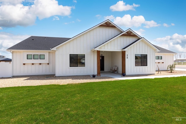 518 Bass Run Ln, Marsing, ID 83639 - back of property with board and batten siding, a yard, and a shingled roof