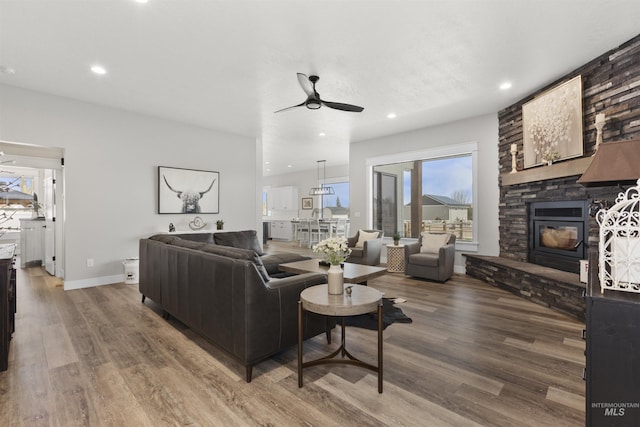 518 Bass Run Ln, Marsing, ID 83639 - living room featuring ceiling fan, wood finished floors, a stone fireplace, and recessed lighting